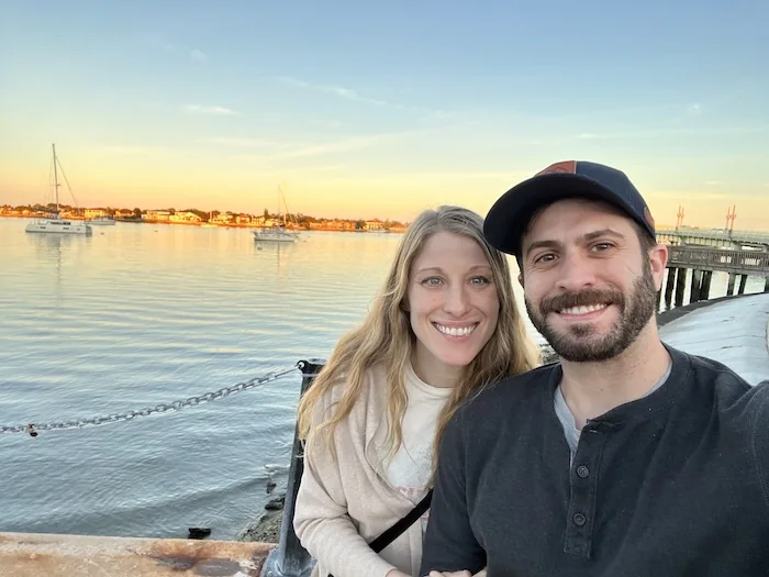 Max and Kristin by the water at sunset